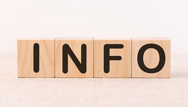 Info word concept written on wooden cubes on a light table and light background